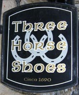 The Three Horseshoes traditional old pub sign with an interlinking horseshoes design